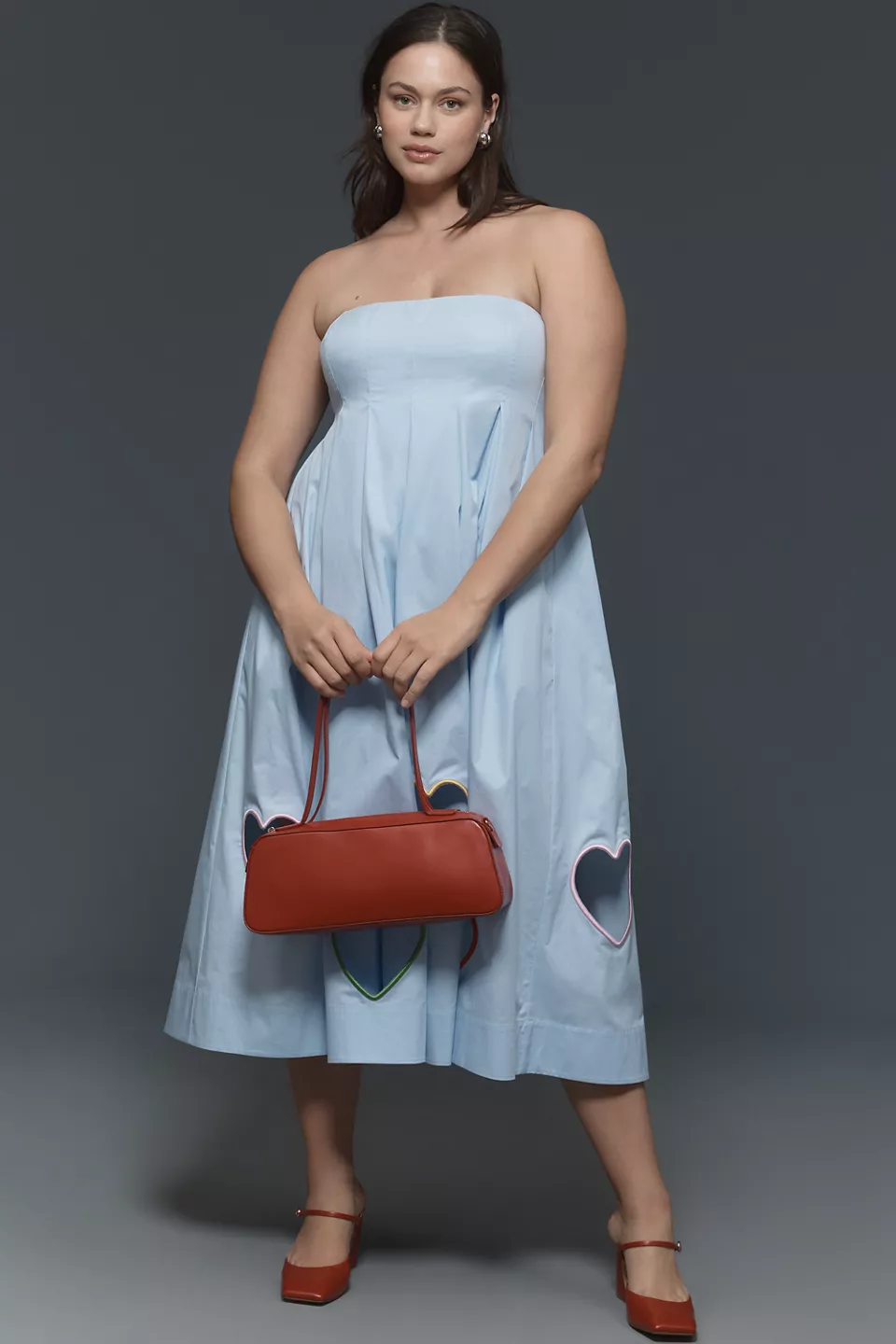 A plus-size light-blue babydoll midi dress with heart cutouts