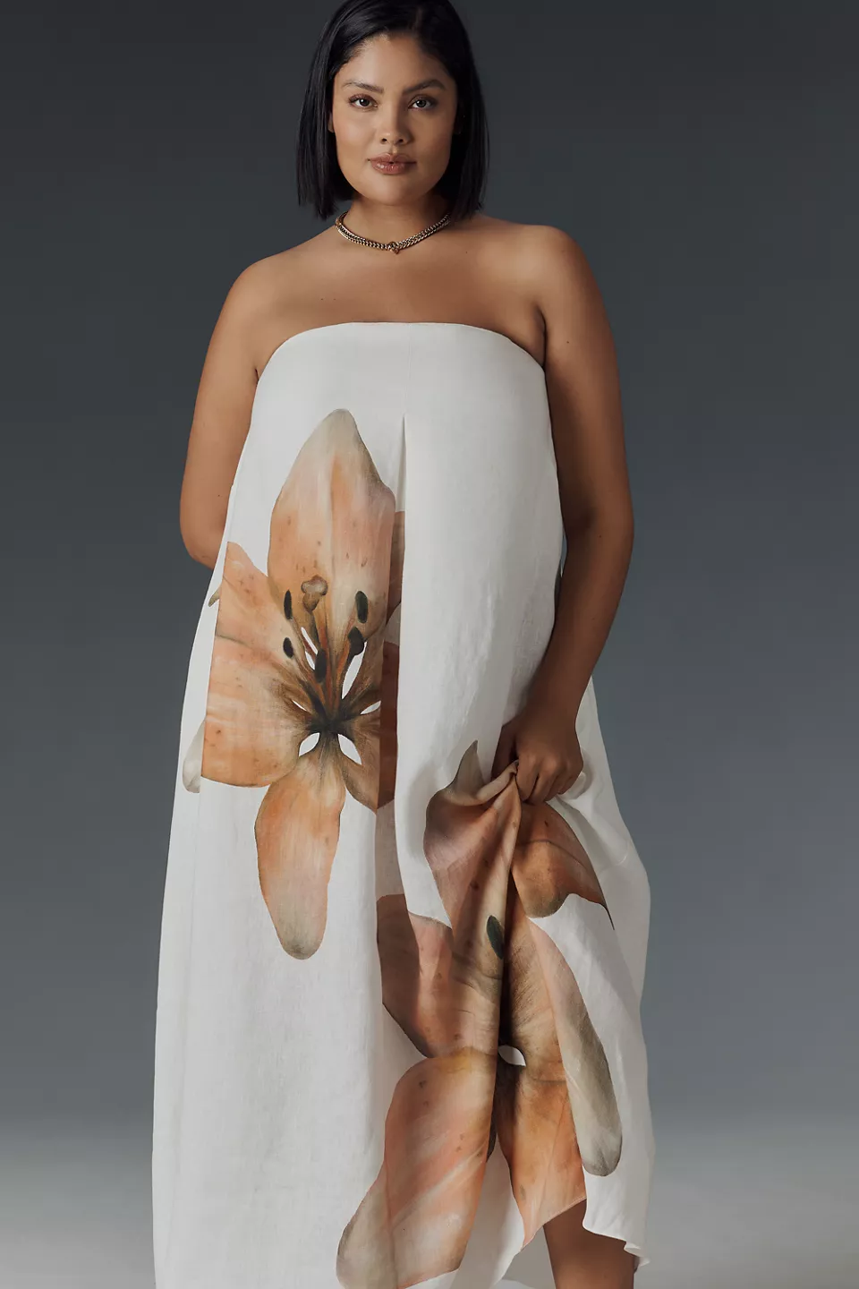 A plus-size, strapless, white-and-pink floral dress