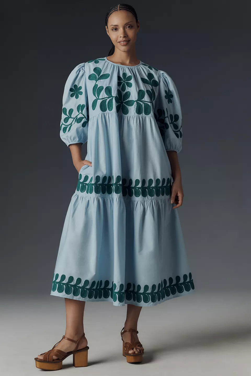 A plus-size, puff-sleeve, light-blue smock dress with green embroidery