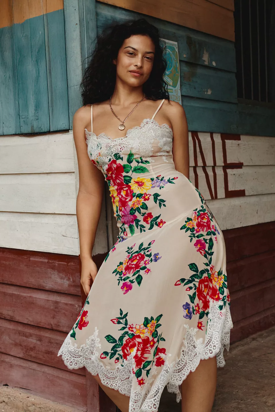 A plus-size floral slip dress with white lace trim