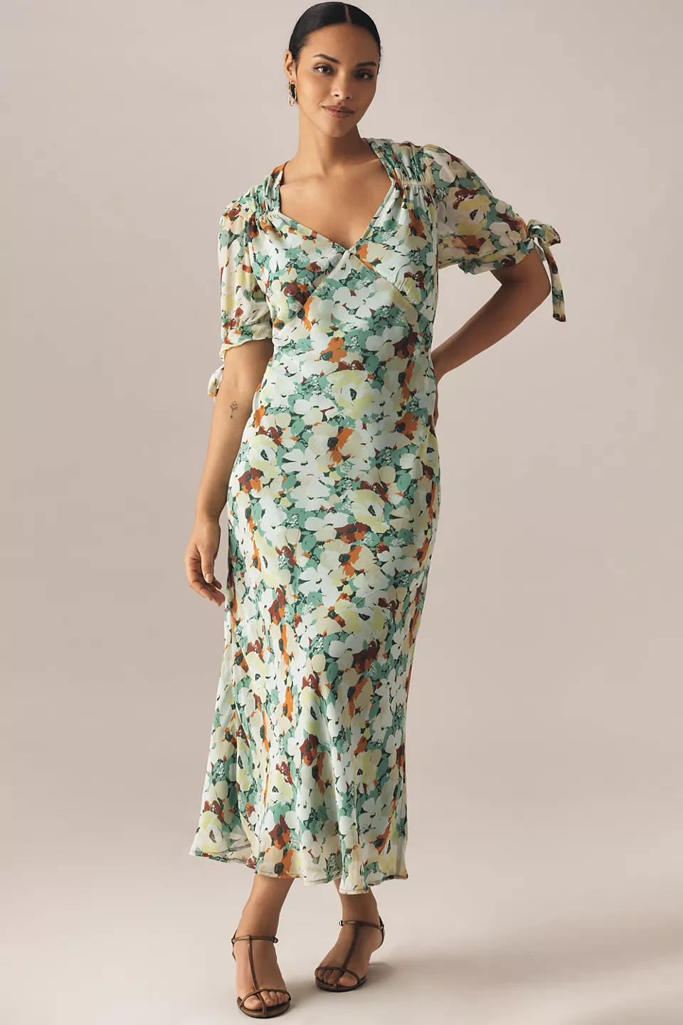 A plus-size, blue-green-and-brown, floral slip dress