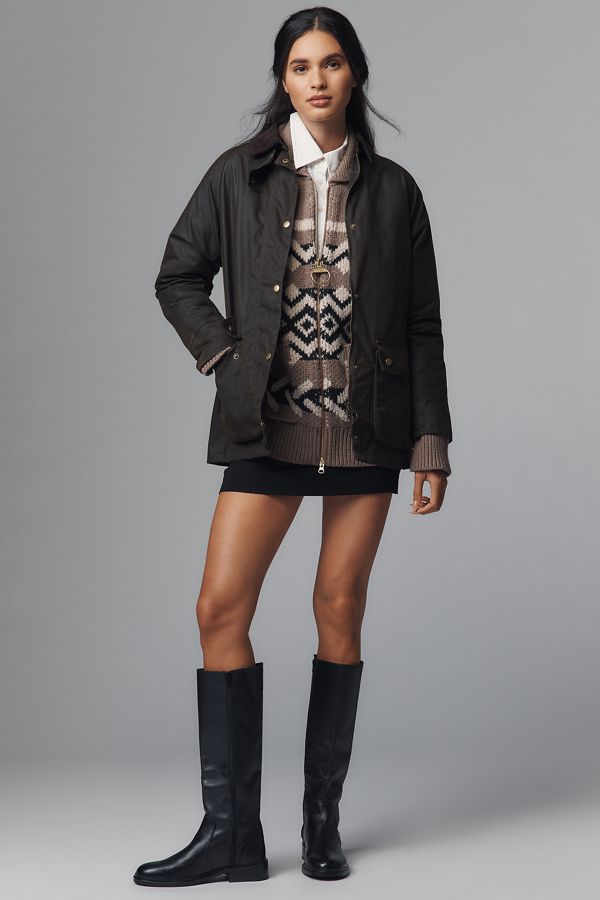 Barn jacket with a contrasting collar layered over a patterned knit