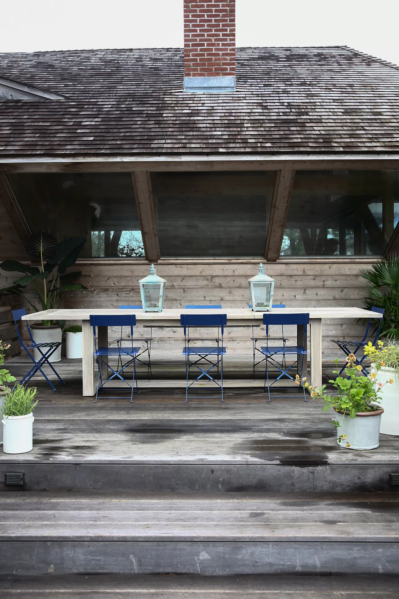 Teak table with four blue chairs