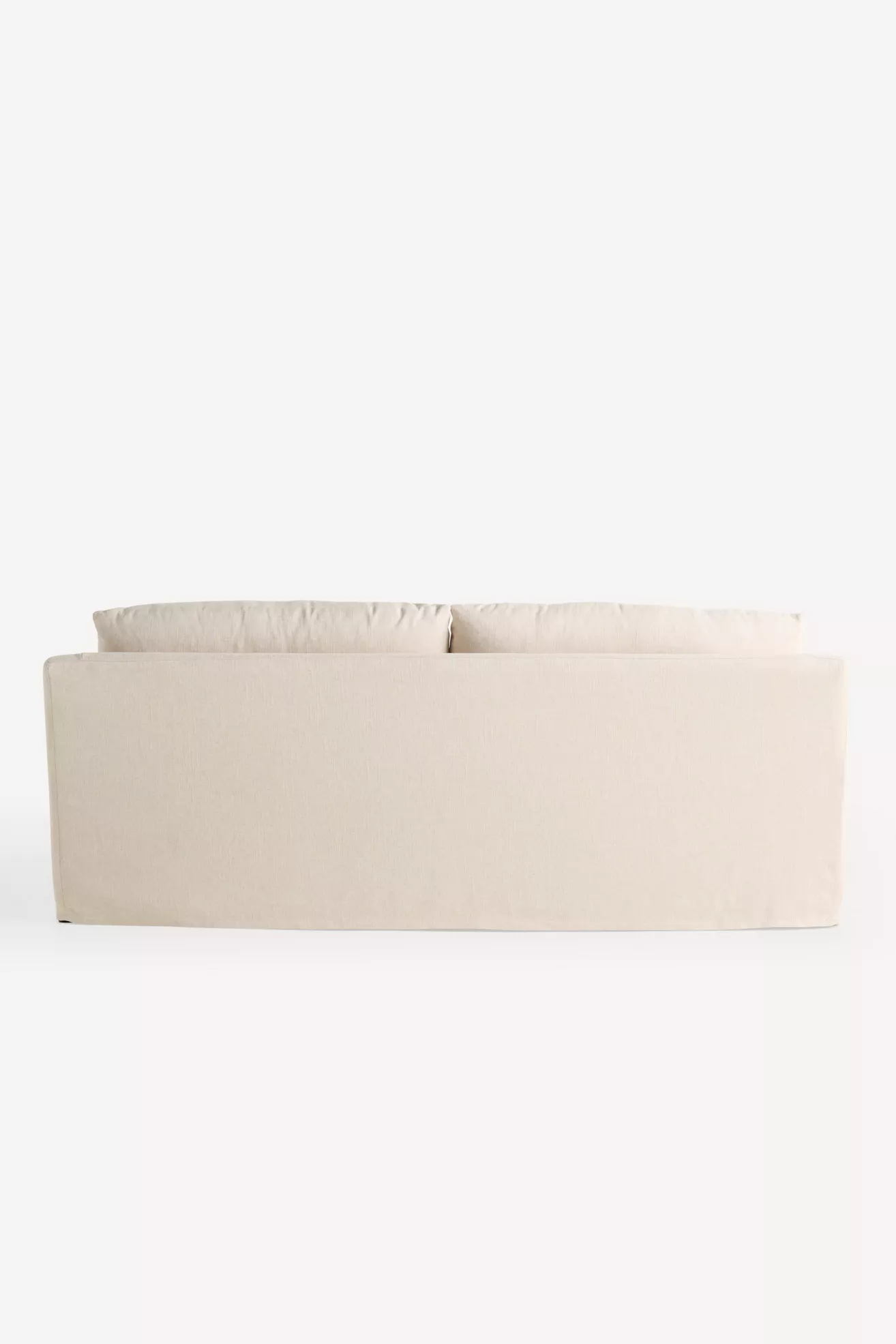 Back view of beige slipcovered sofa