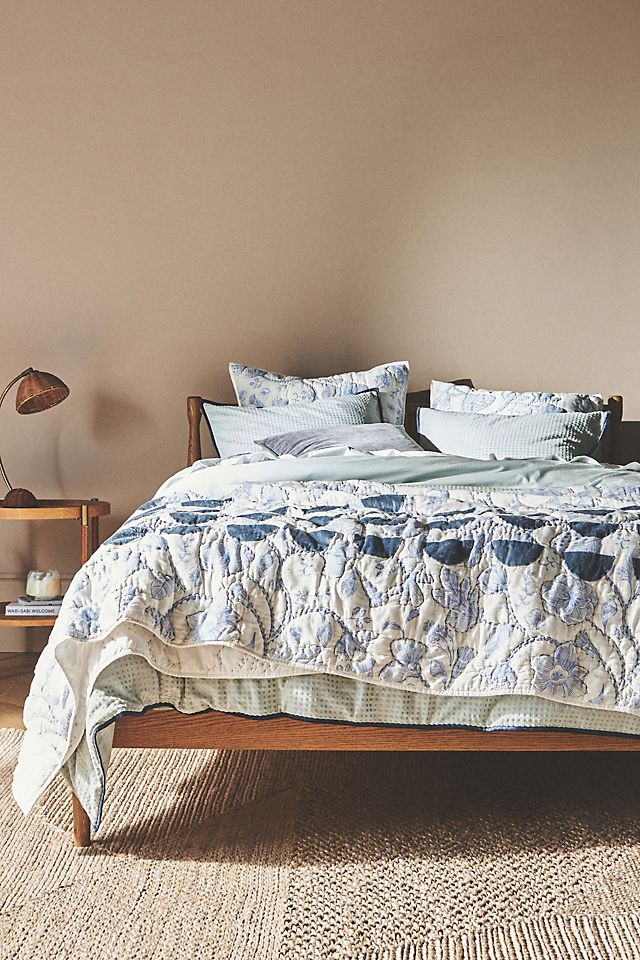 Quilts offer texture for a cozy, charming French style oasis 