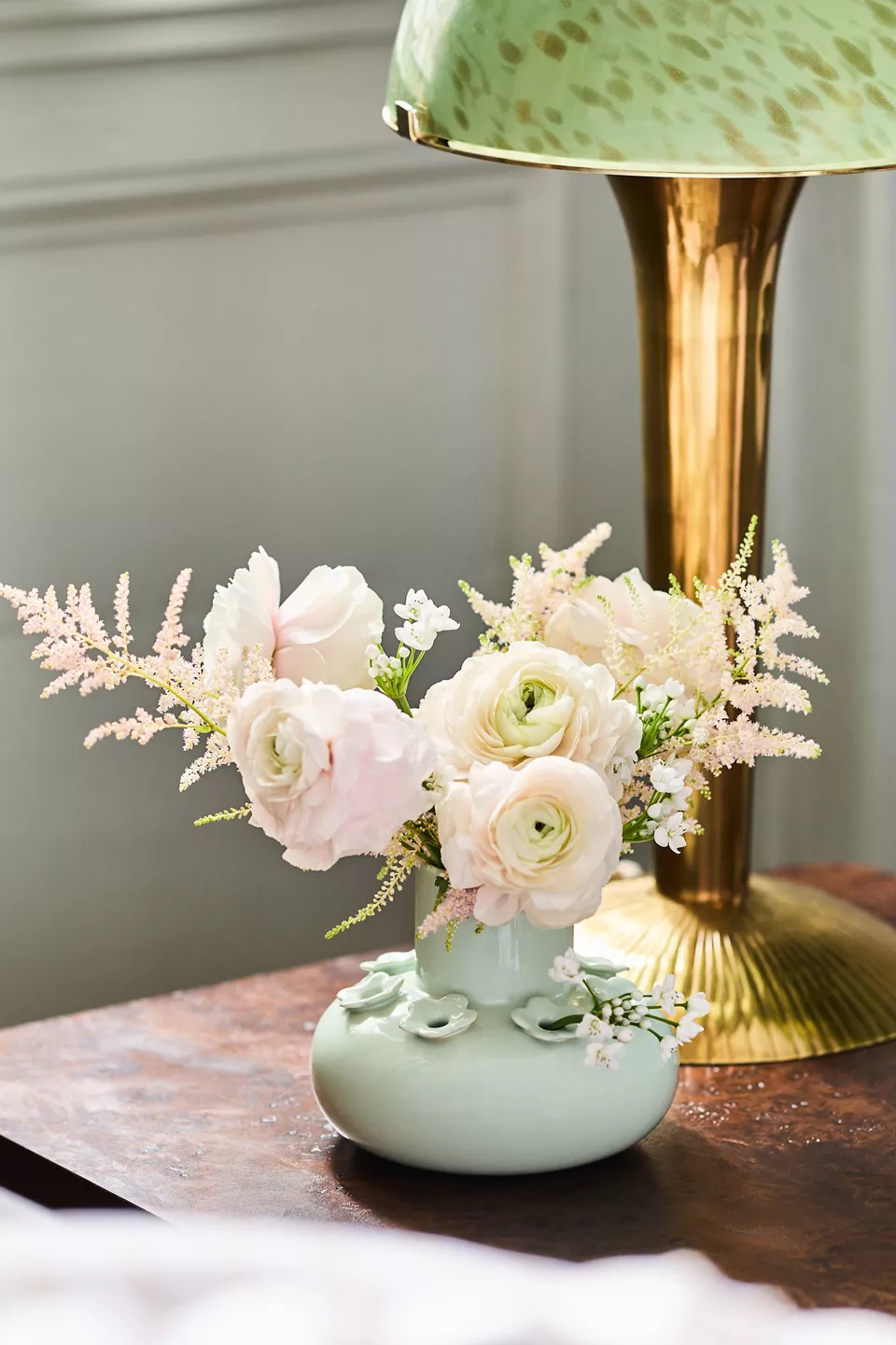 Anthrohome Nova Ceramic Tulipere Vase in cream with a ruffled tulip-shaped opening on a shelf