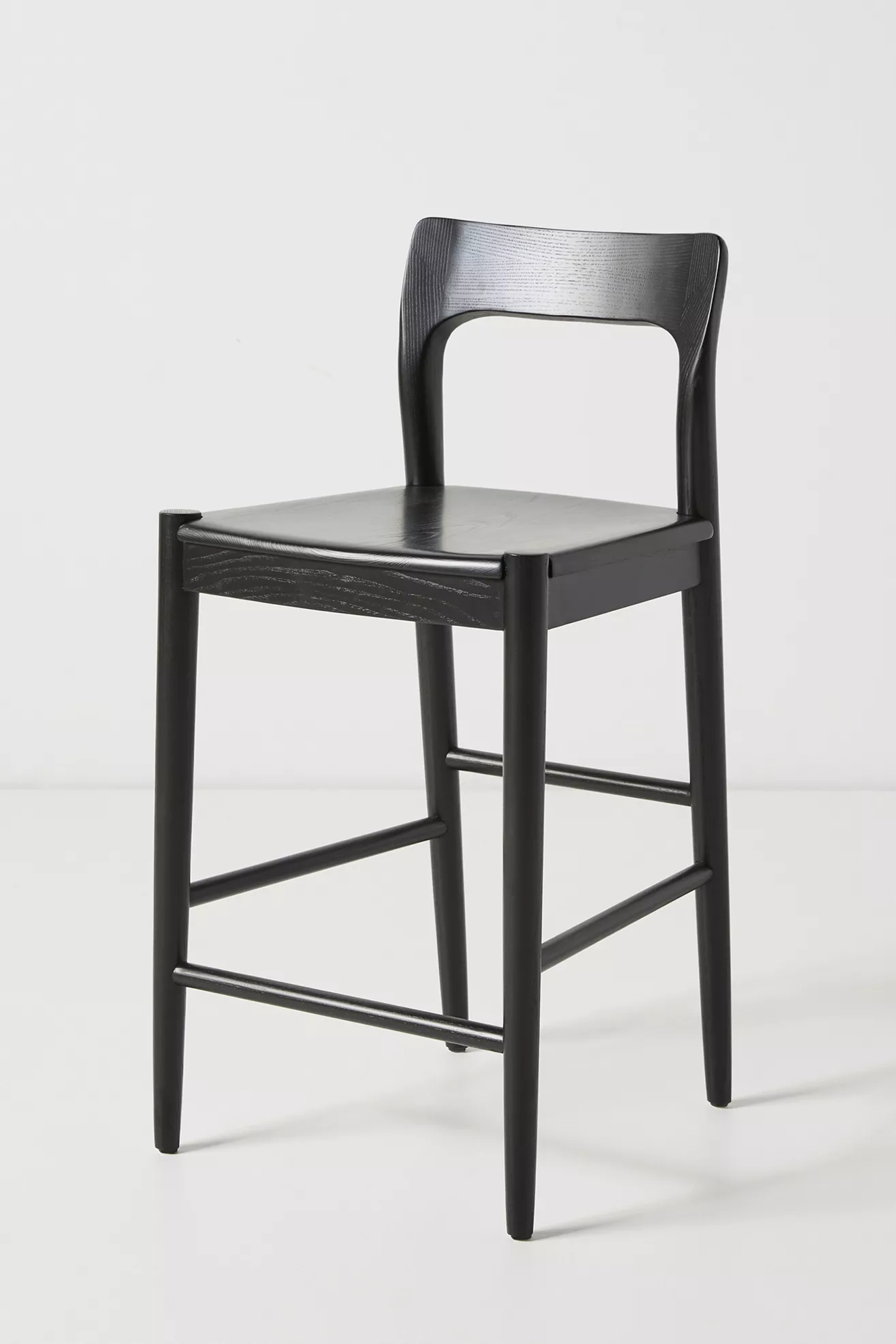 Front view of a black ash wood counter stool with visible seat and back