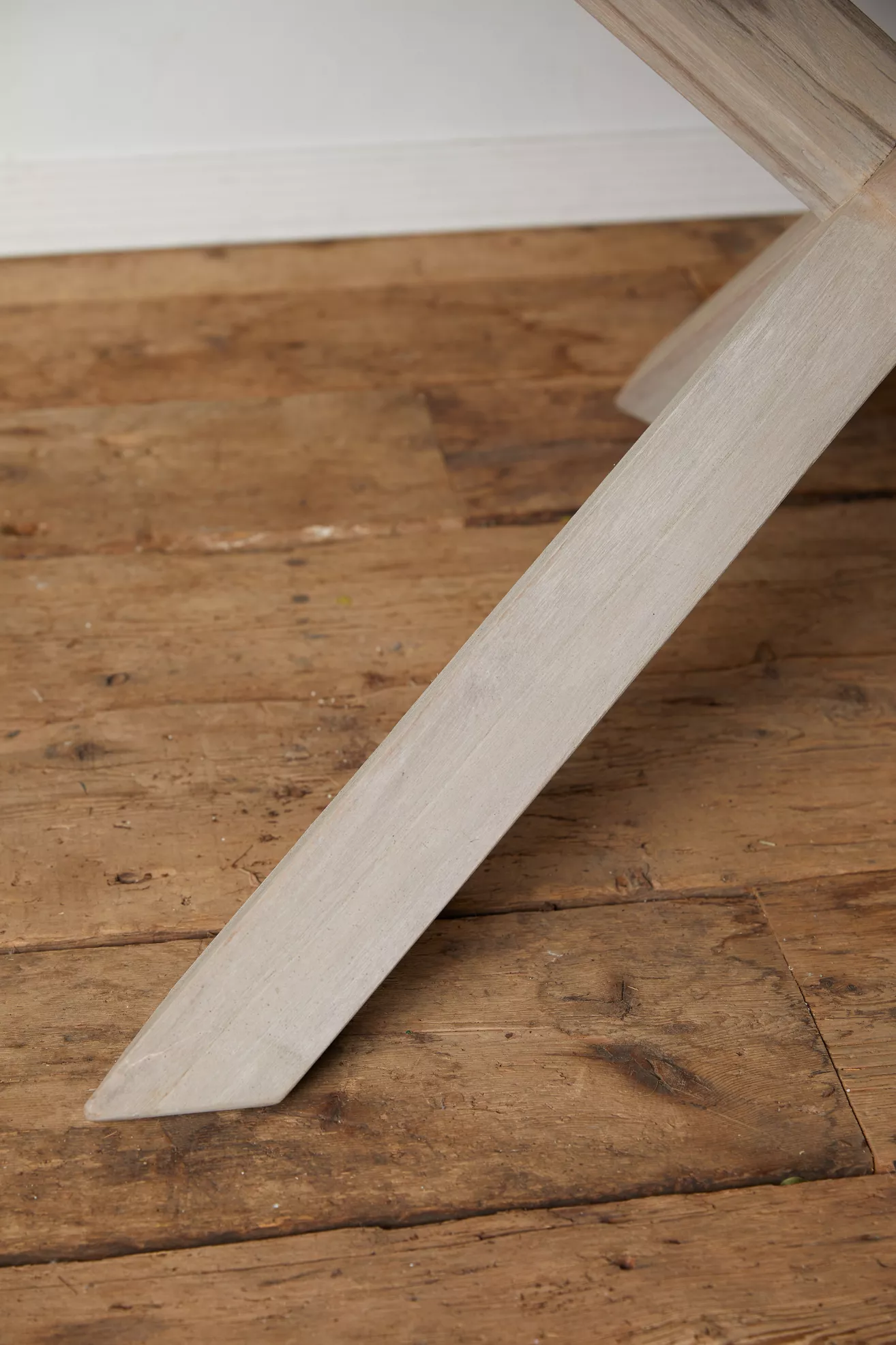 Close-up of table leg and floor, showing finish and angle