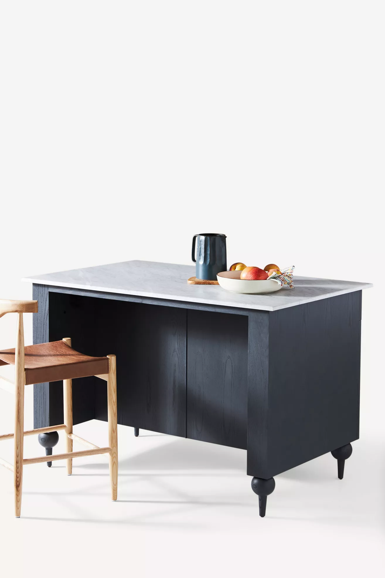 Isometric view of dark blue kitchen island with marble top