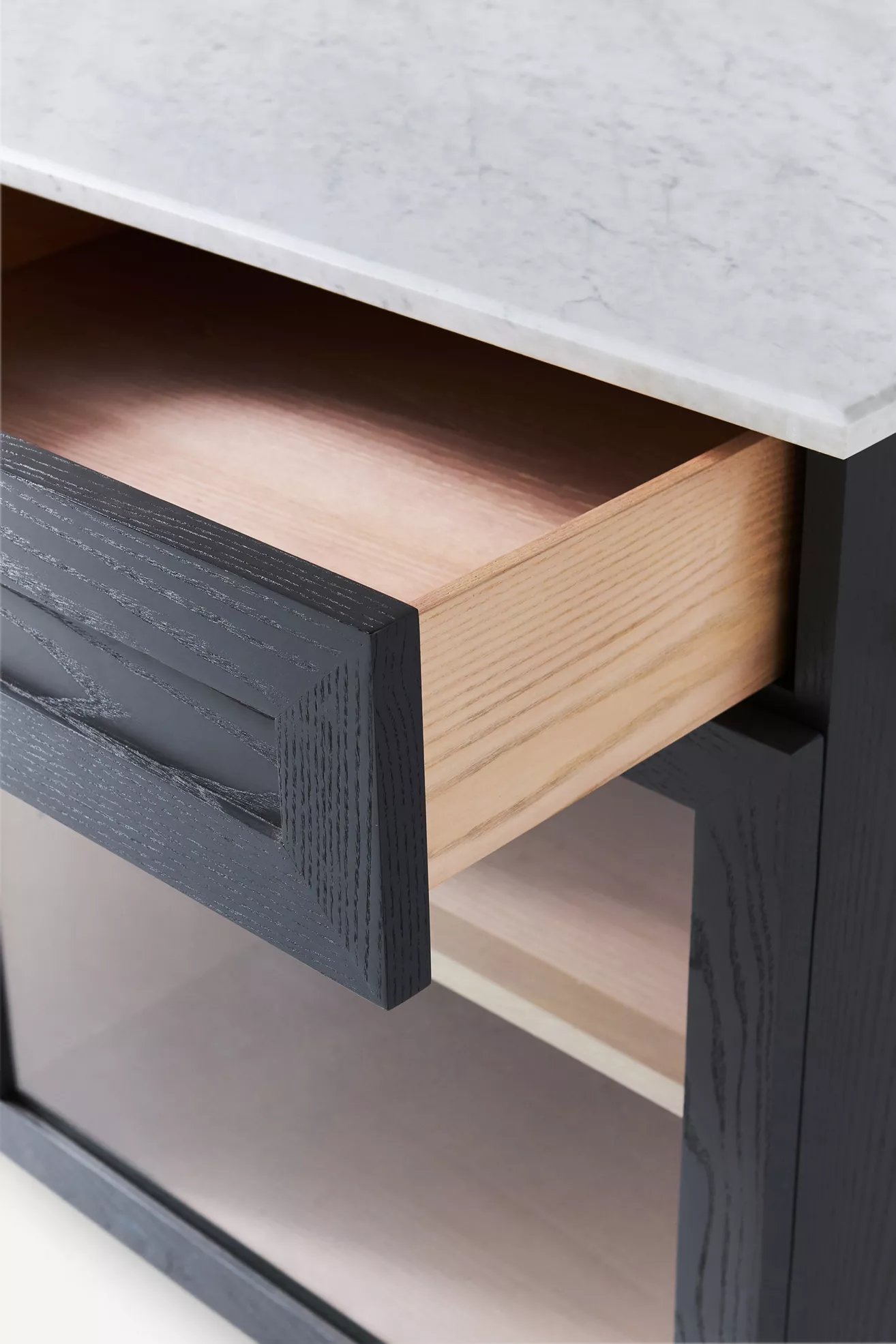 Drawer pull and wood grain on navy cabinet
