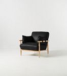 Black leather chair with light wood frame