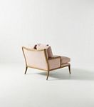 Back and side view of pink chaise with wooden frame