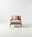 Pink upholstered chaise seat with cushions and wooden legs