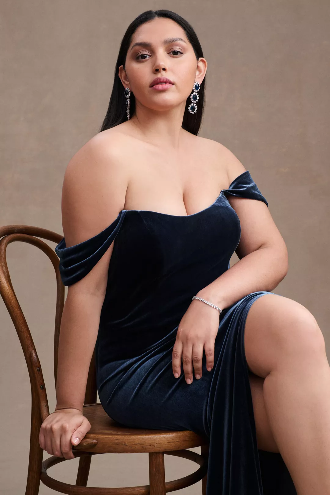 A plus-size, blue, off-the-shoulder velvet gown