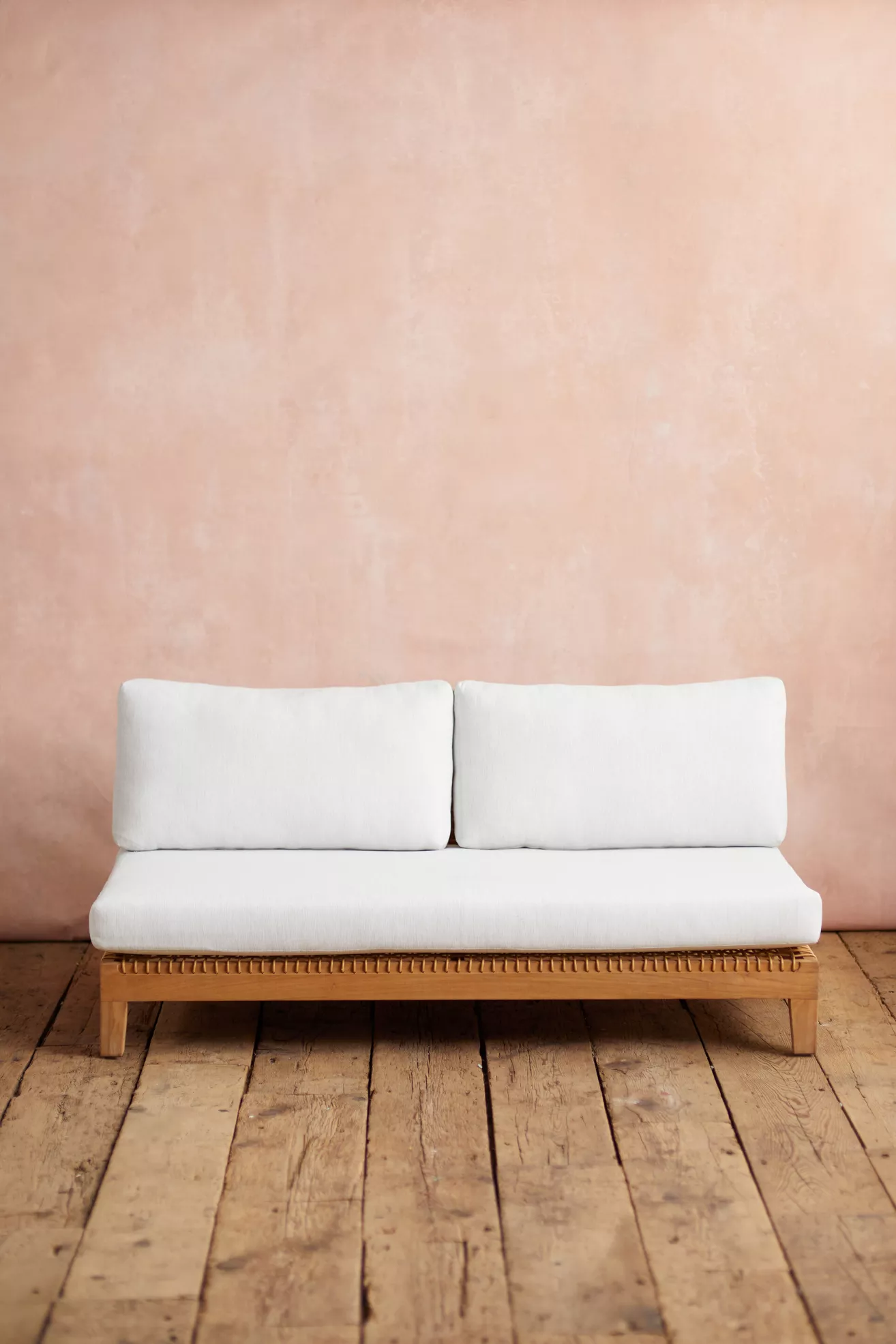 two white seat cushions on sofa with wooden base