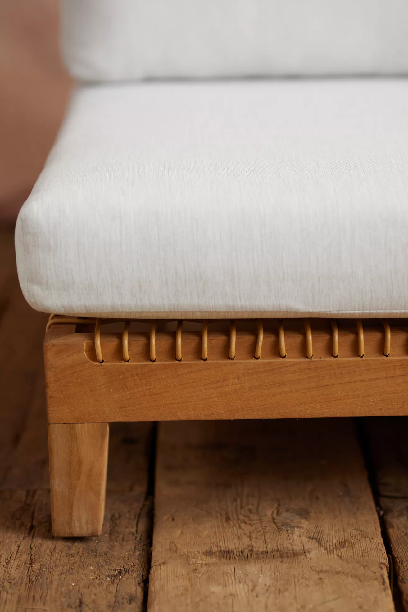 close-up of white cushion on wooden sofa frame