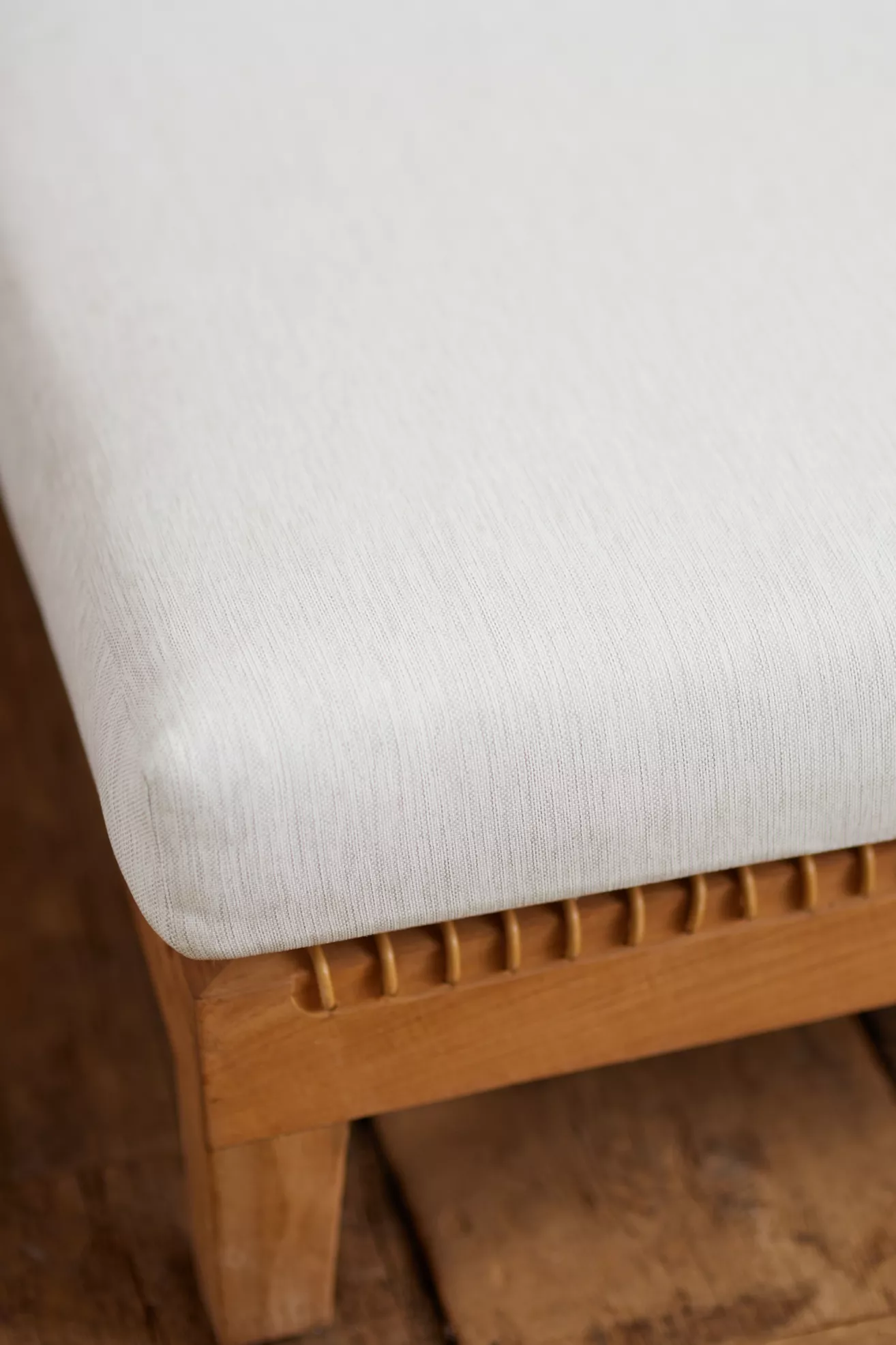 corner of sofa cushion and wooden frame