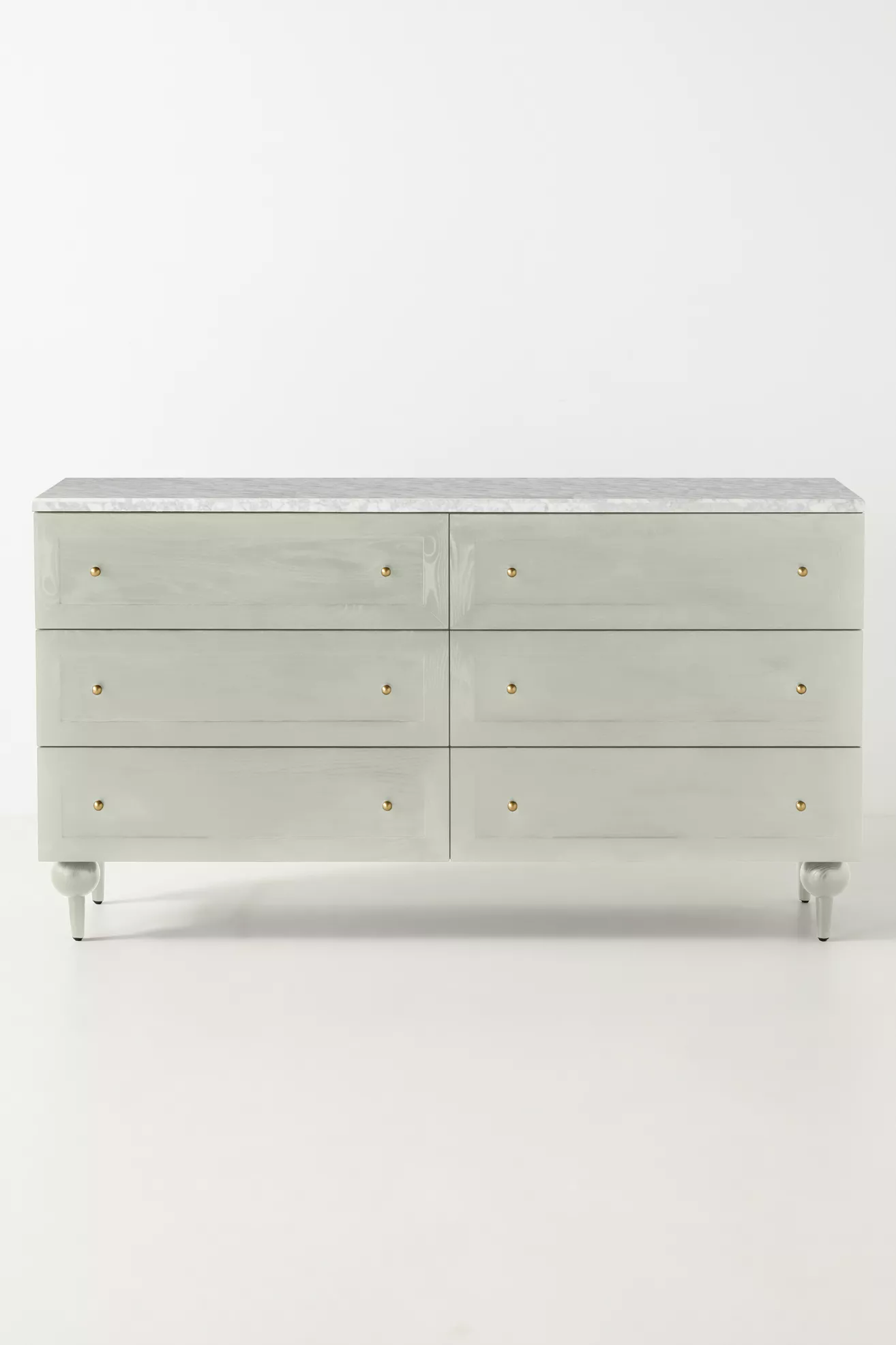 Light gray/white six-drawer dresser with gold knobs and turned legs