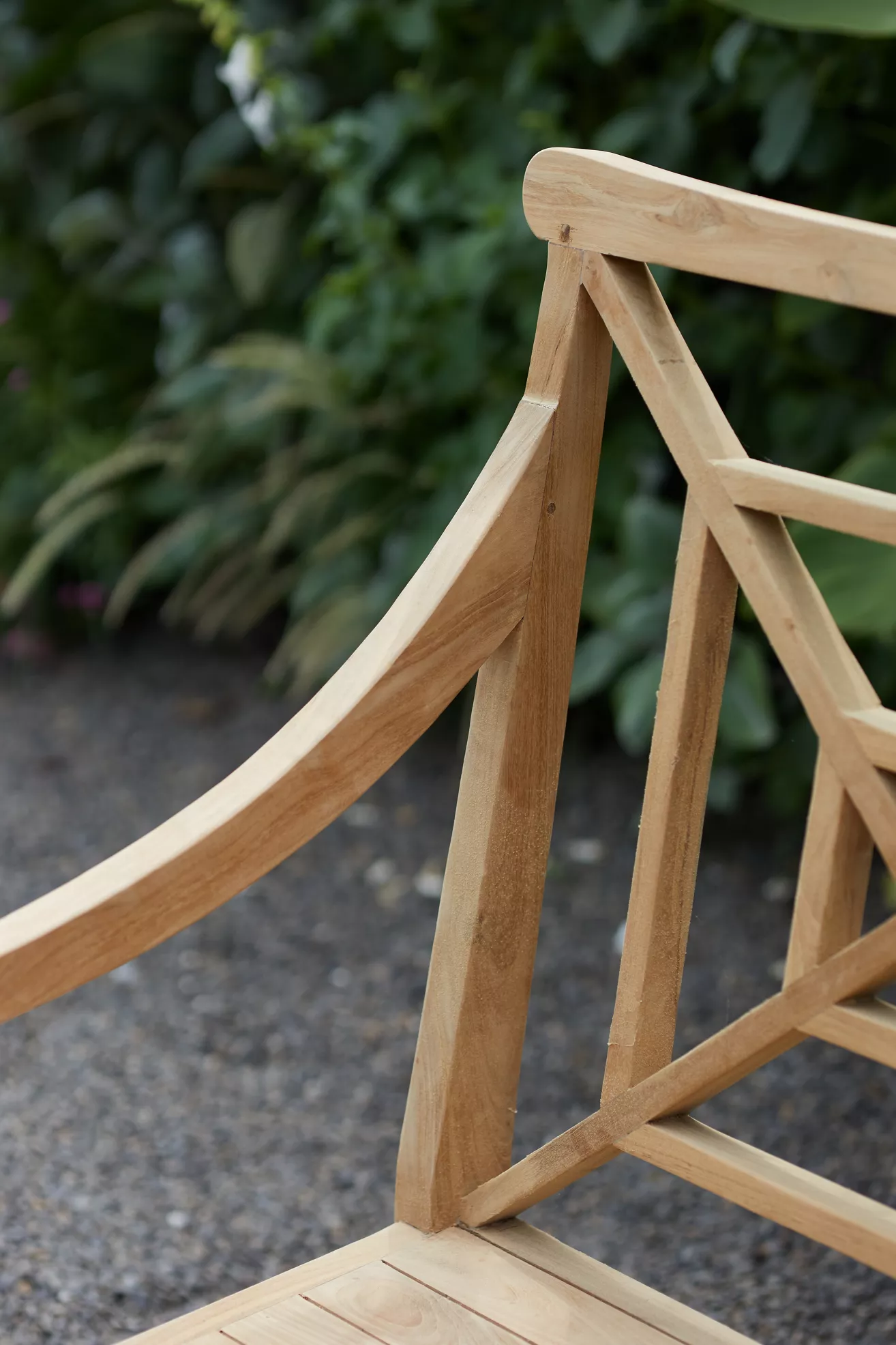 Close-up of bench joint where curved back rail meets vertical support