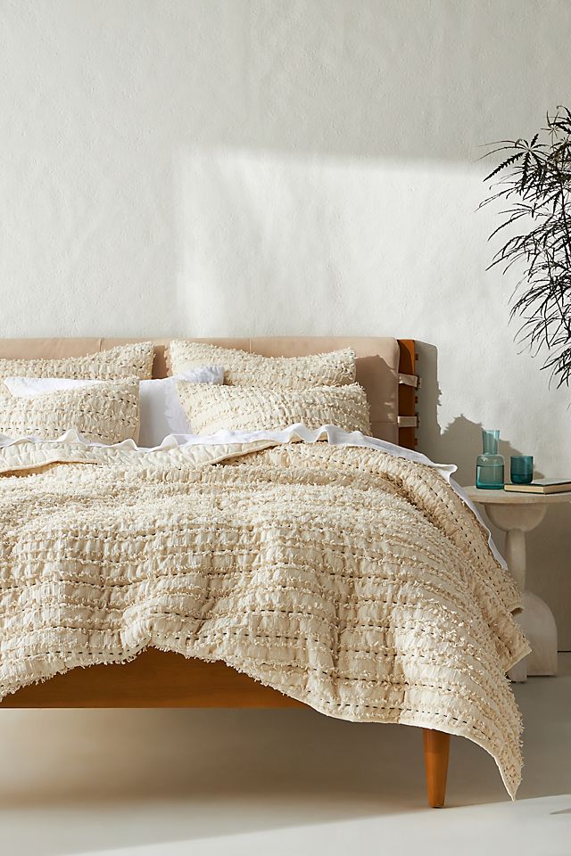 Quilts offer texture for a cozy, charming French style oasis 