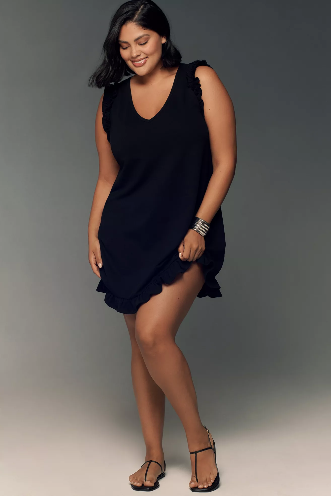 A plus-size black mini dress with frill details