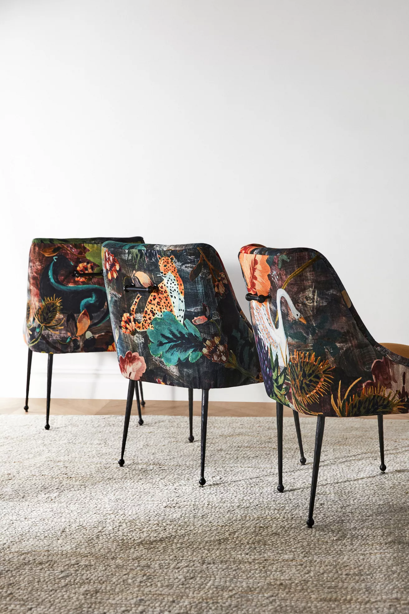 Three velvet dining chairs with matching prints lined up