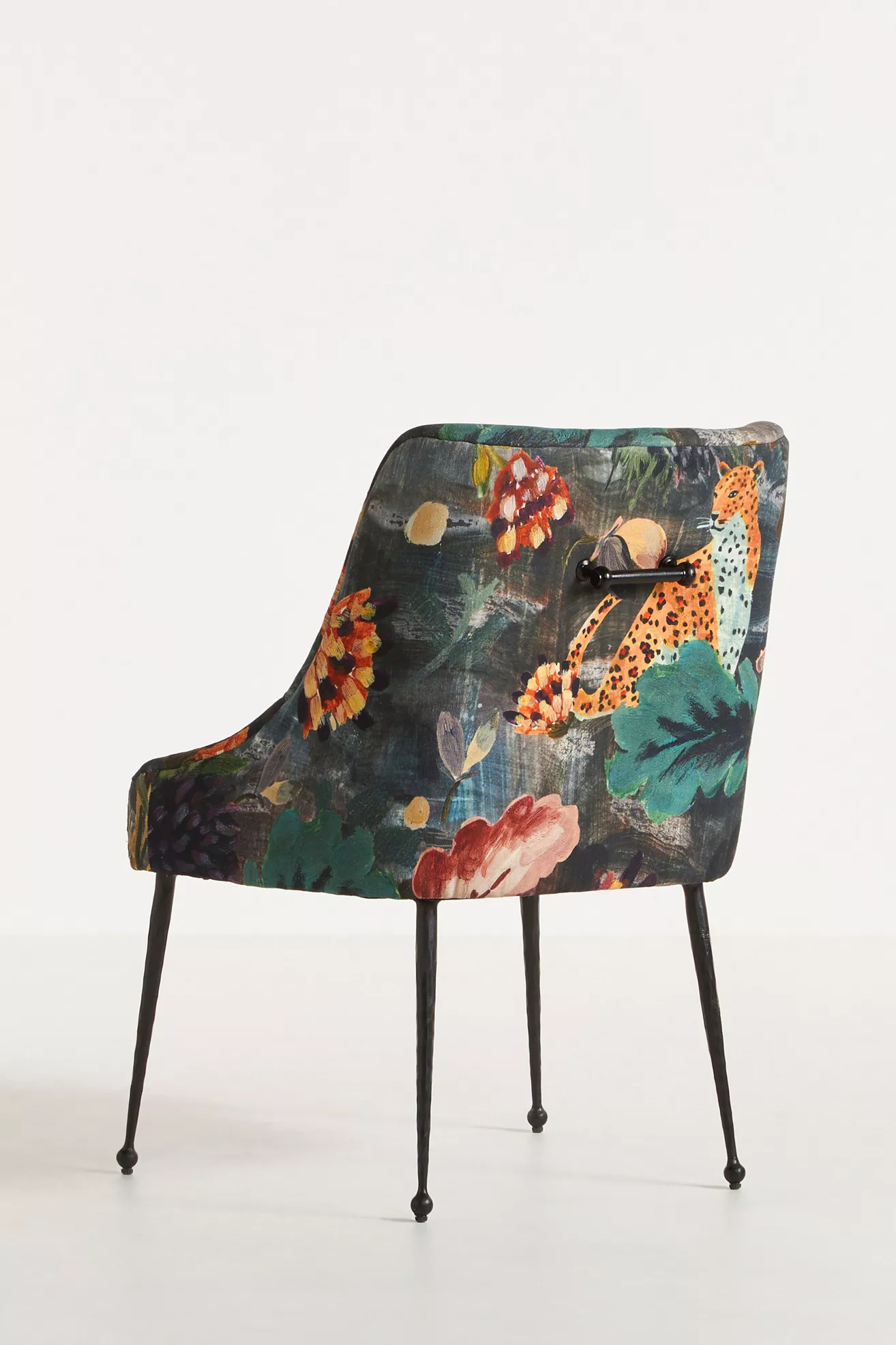 Back view of velvet floral dining chair with handle