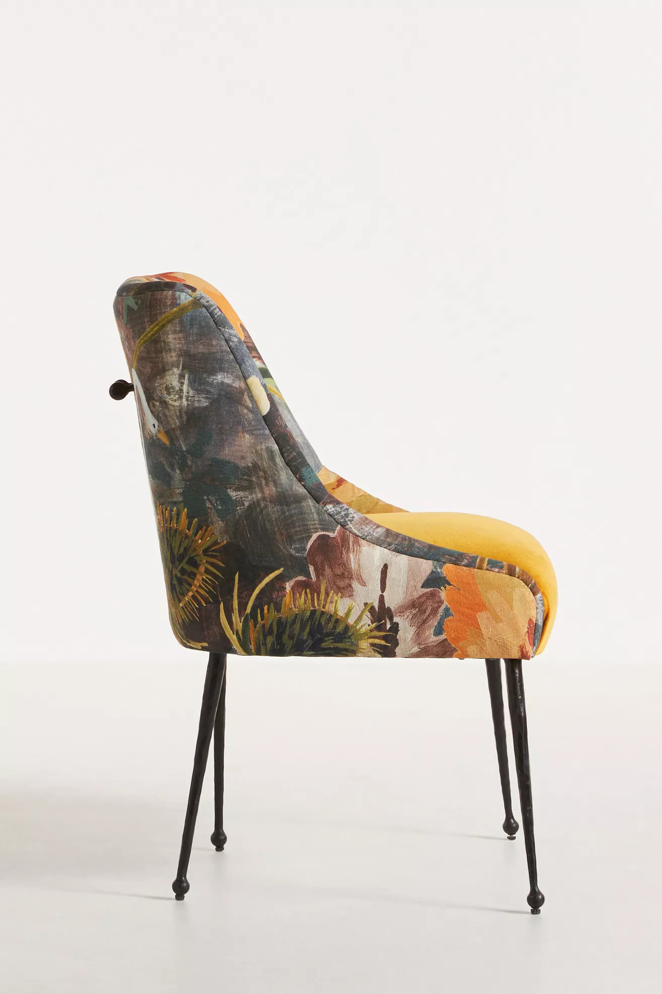 side profile of velvet chair with floral print and amber seat