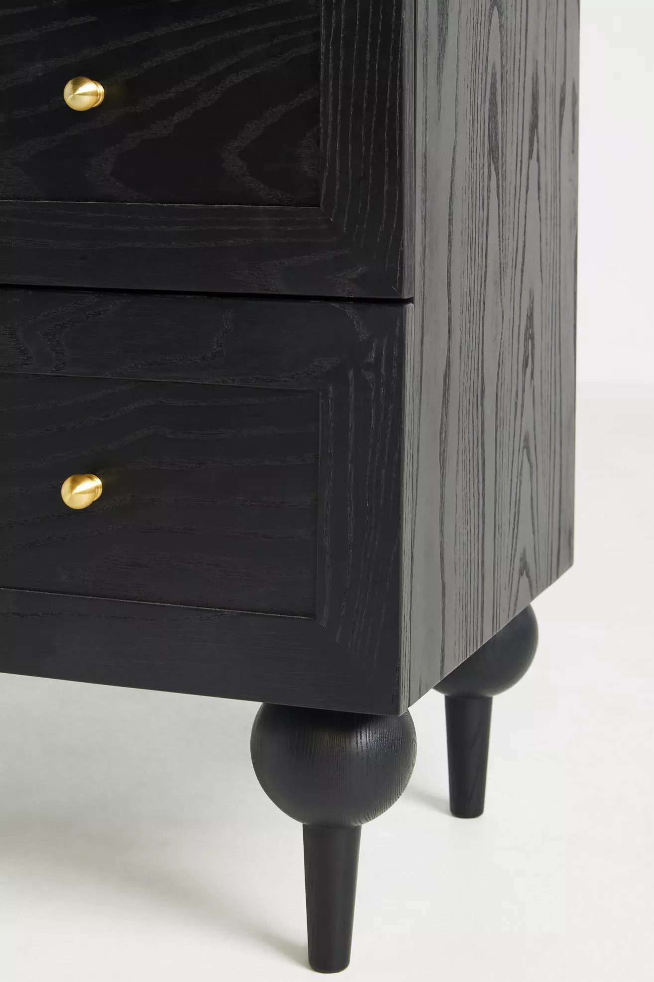 Close-up of drawer front and gold knob