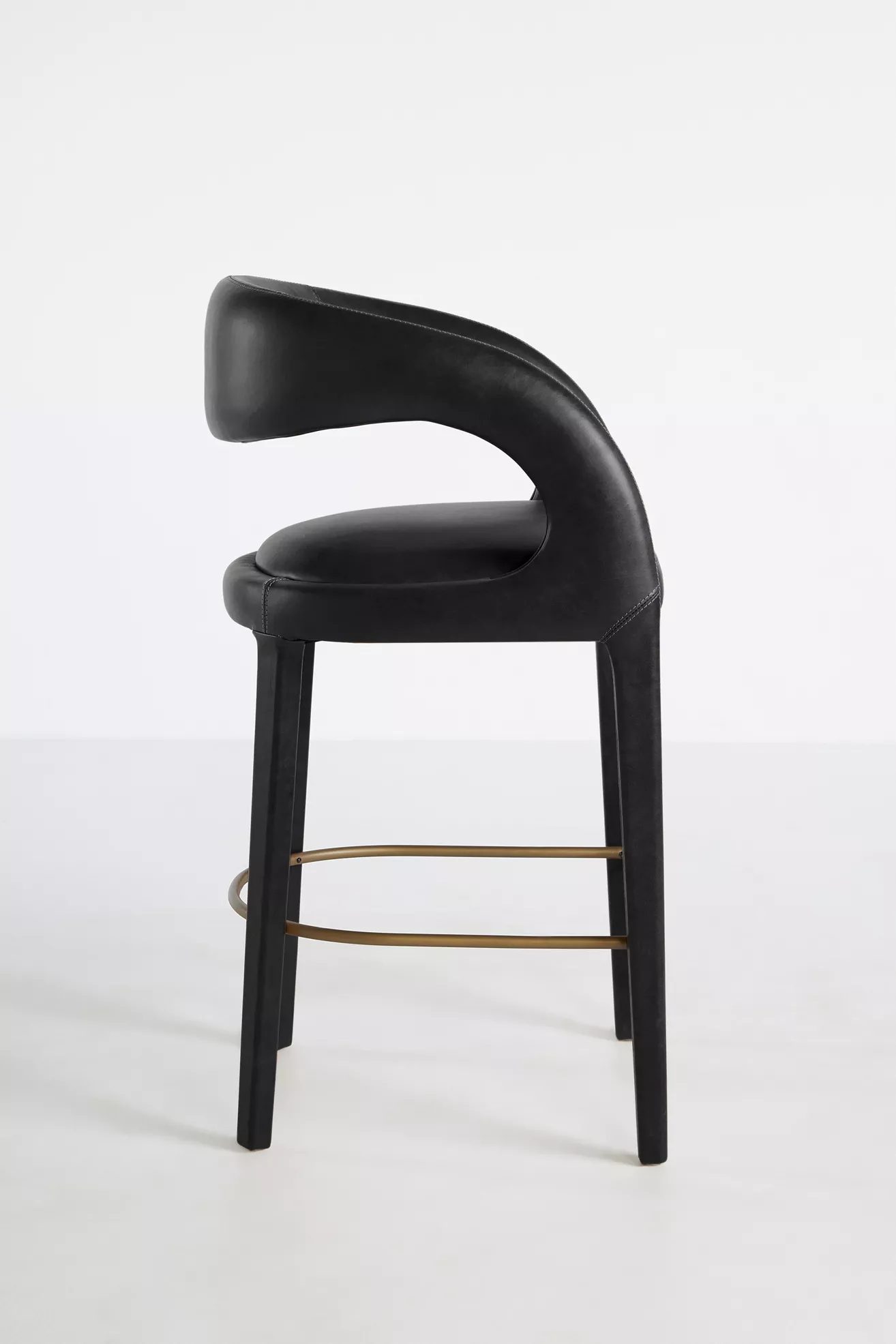 Leather Hagen counter stool profile with curved back and footrest