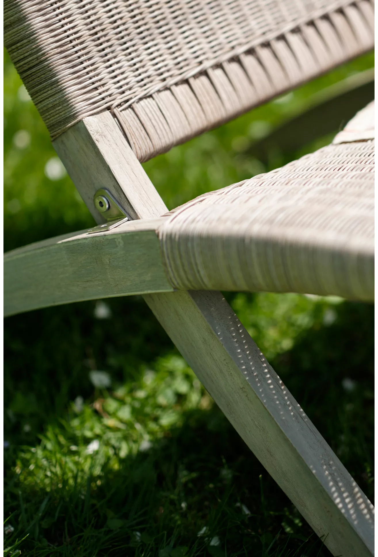 Close-up of woven wicker and joint hardware on folding chair