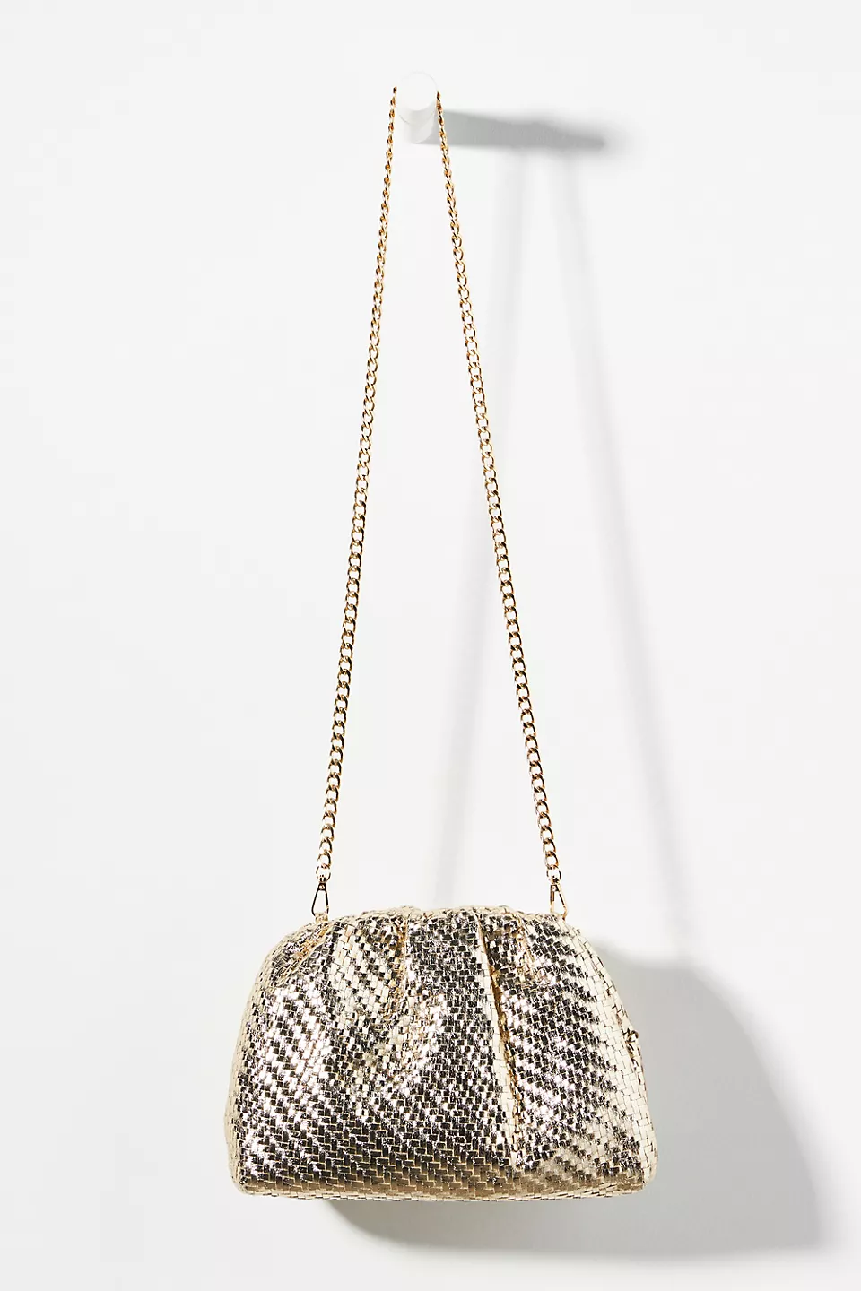 Gold, long-chain Frankie clutch on a white background