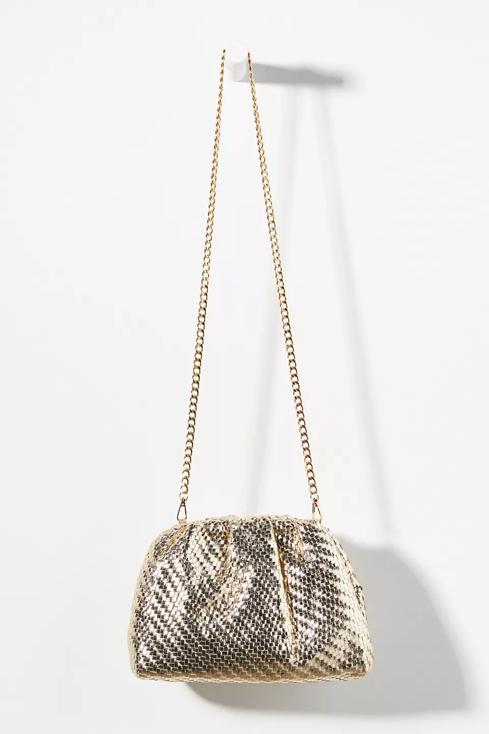 Gold, long-chain Frankie clutch on a white background