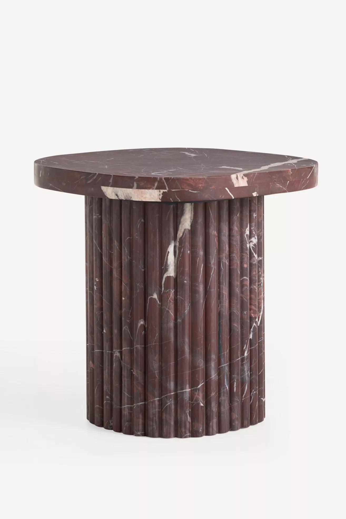 Close-up of marble tabletop edge and fluted base of Kanta side table