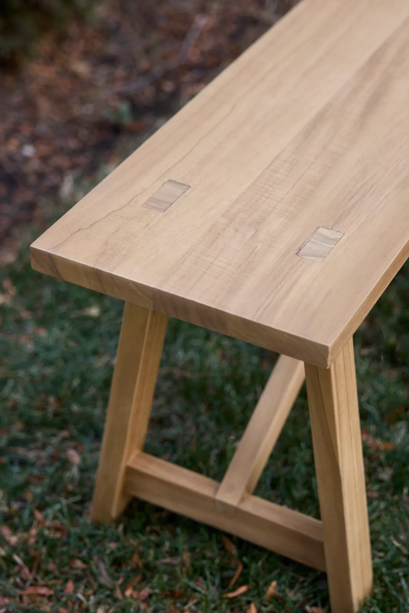End of teak bench showing square joinery on the top surface