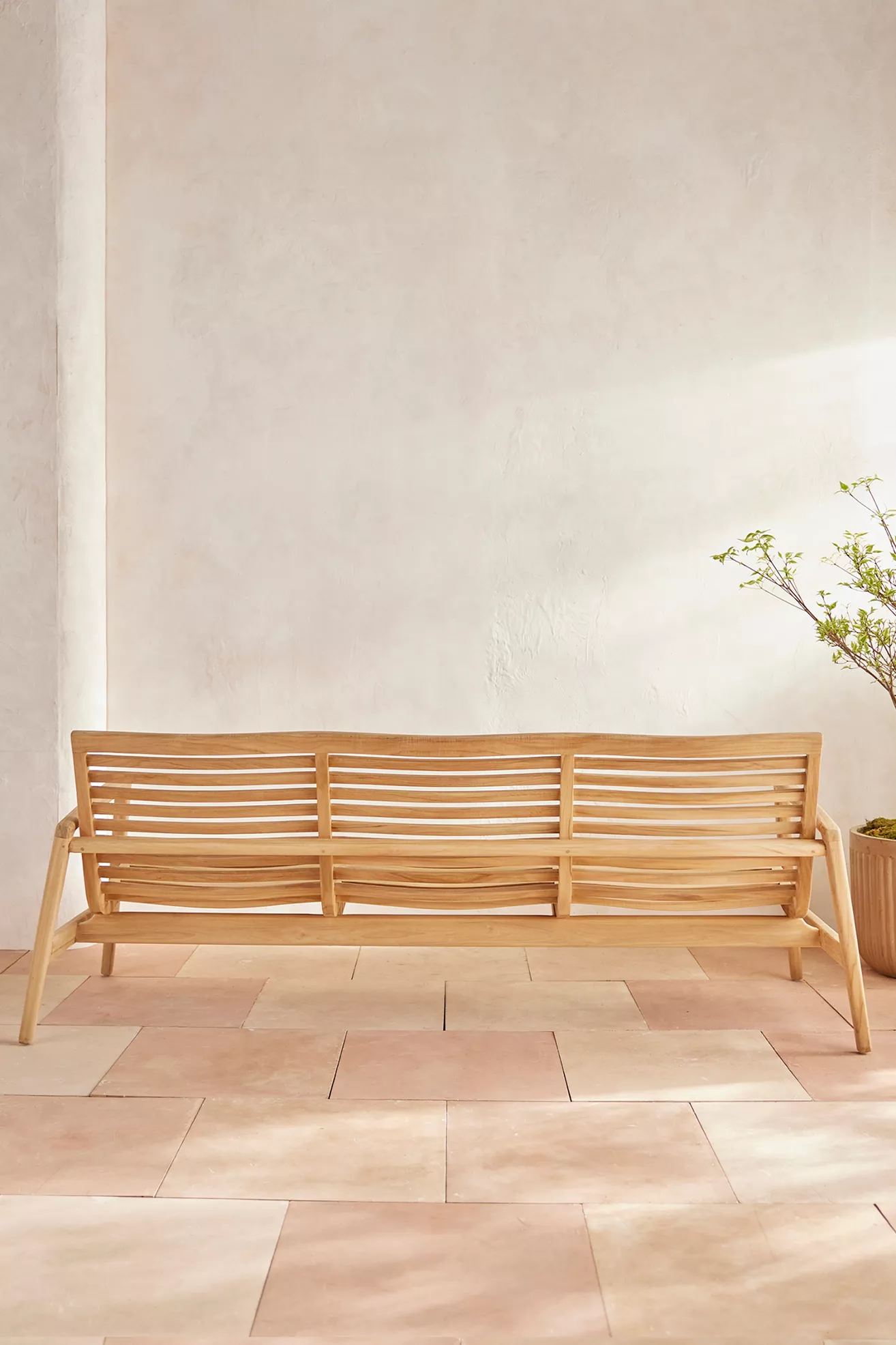 Full view of teak outdoor sofa from front