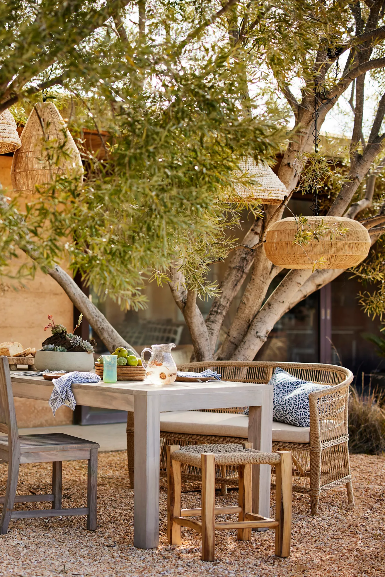 Outdoor yard with dining set and woven seating under trees