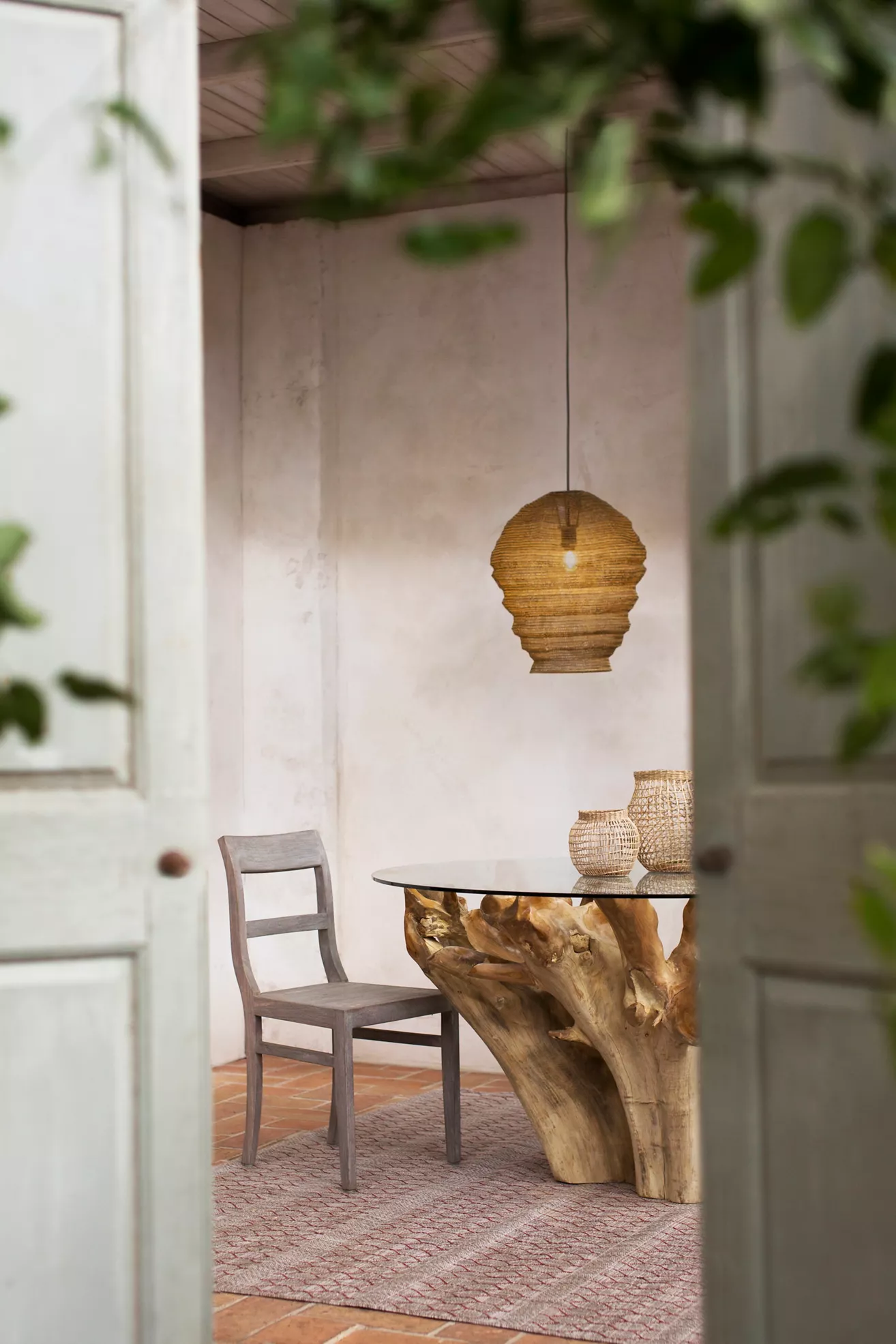 Noni chairs with a round wooden table in an outdoor dining setting