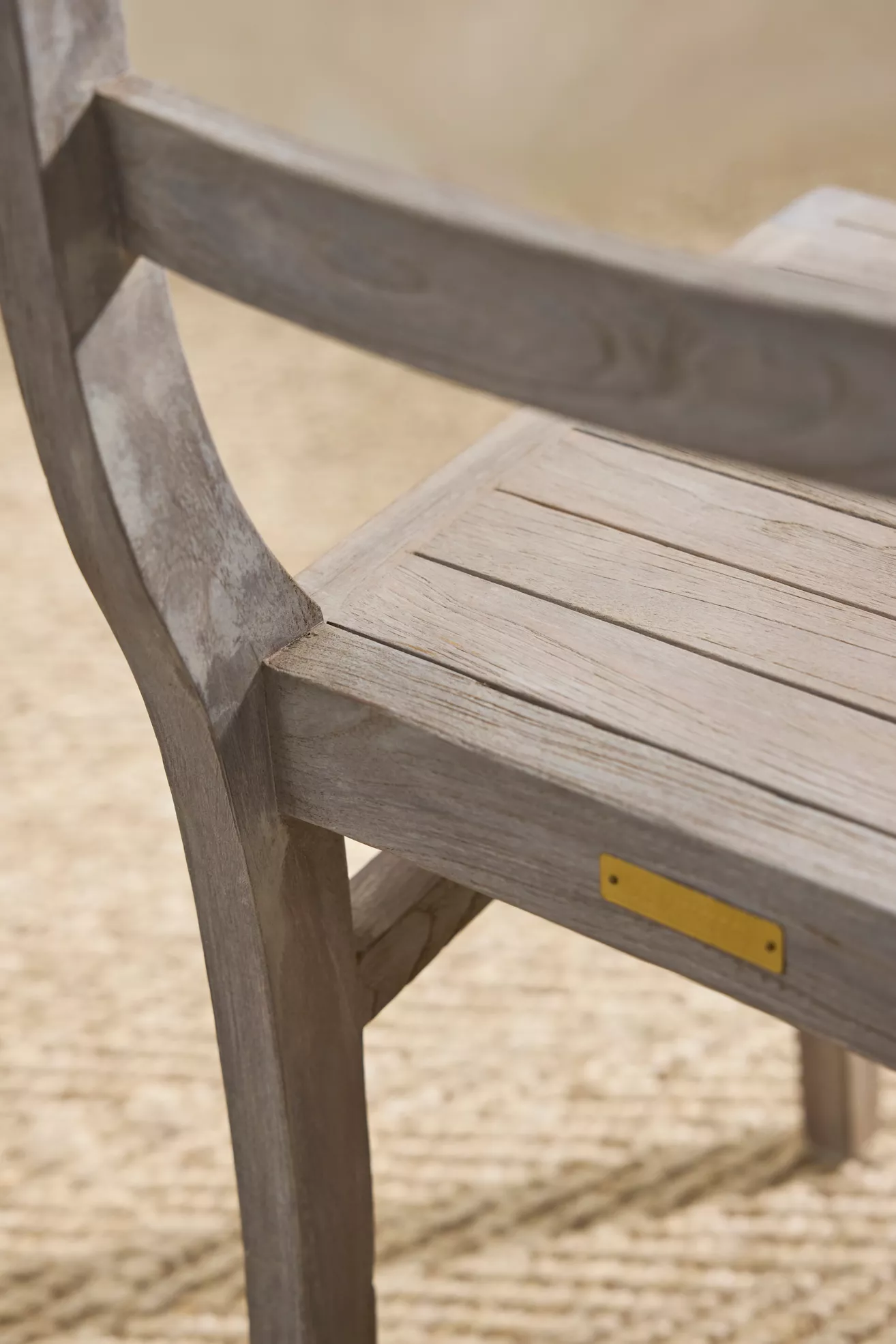 Close-up of chair back edge with small brass plate
