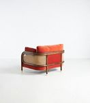 Heatherfield chair side view with coral-red upholstery and cane frame
