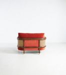 Heatherfield chair side view with coral-red upholstery and cane-wrapped back