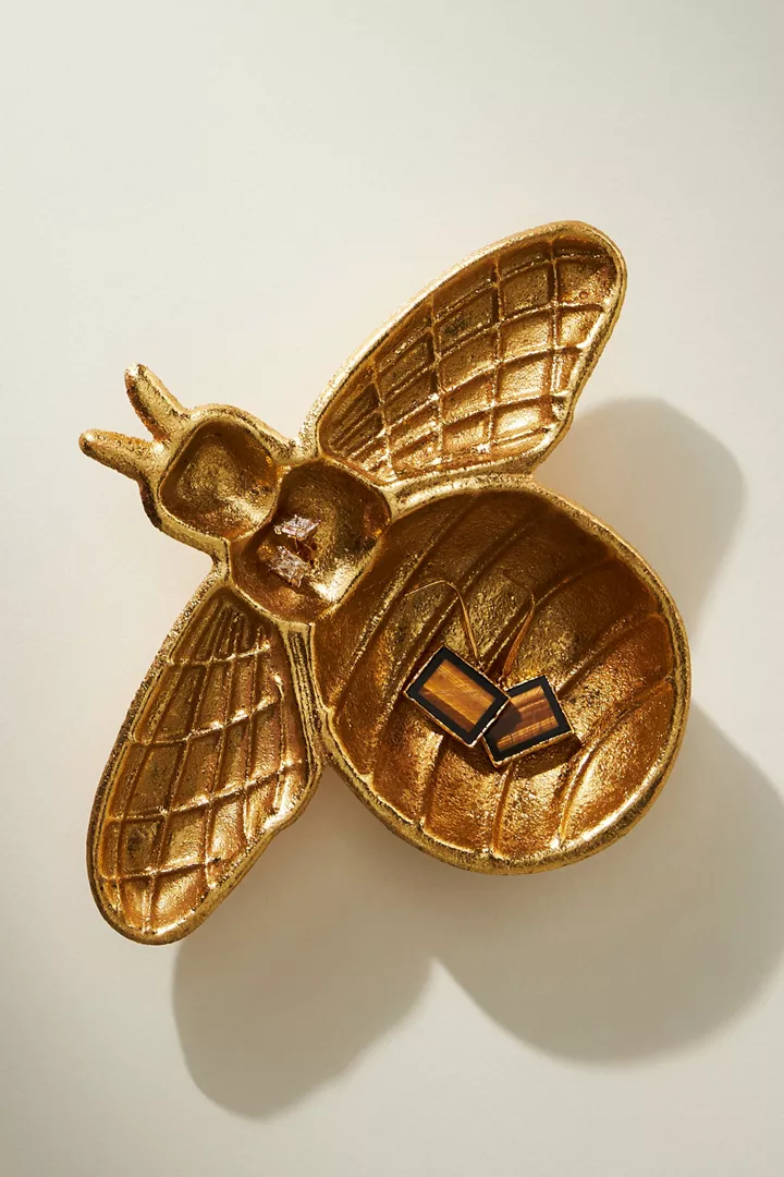 A gold dish shaped like a bee