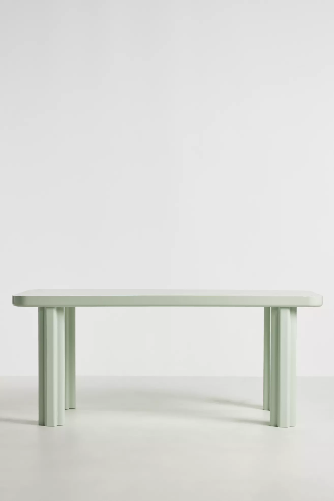 Side view of rectangular pale green dining table