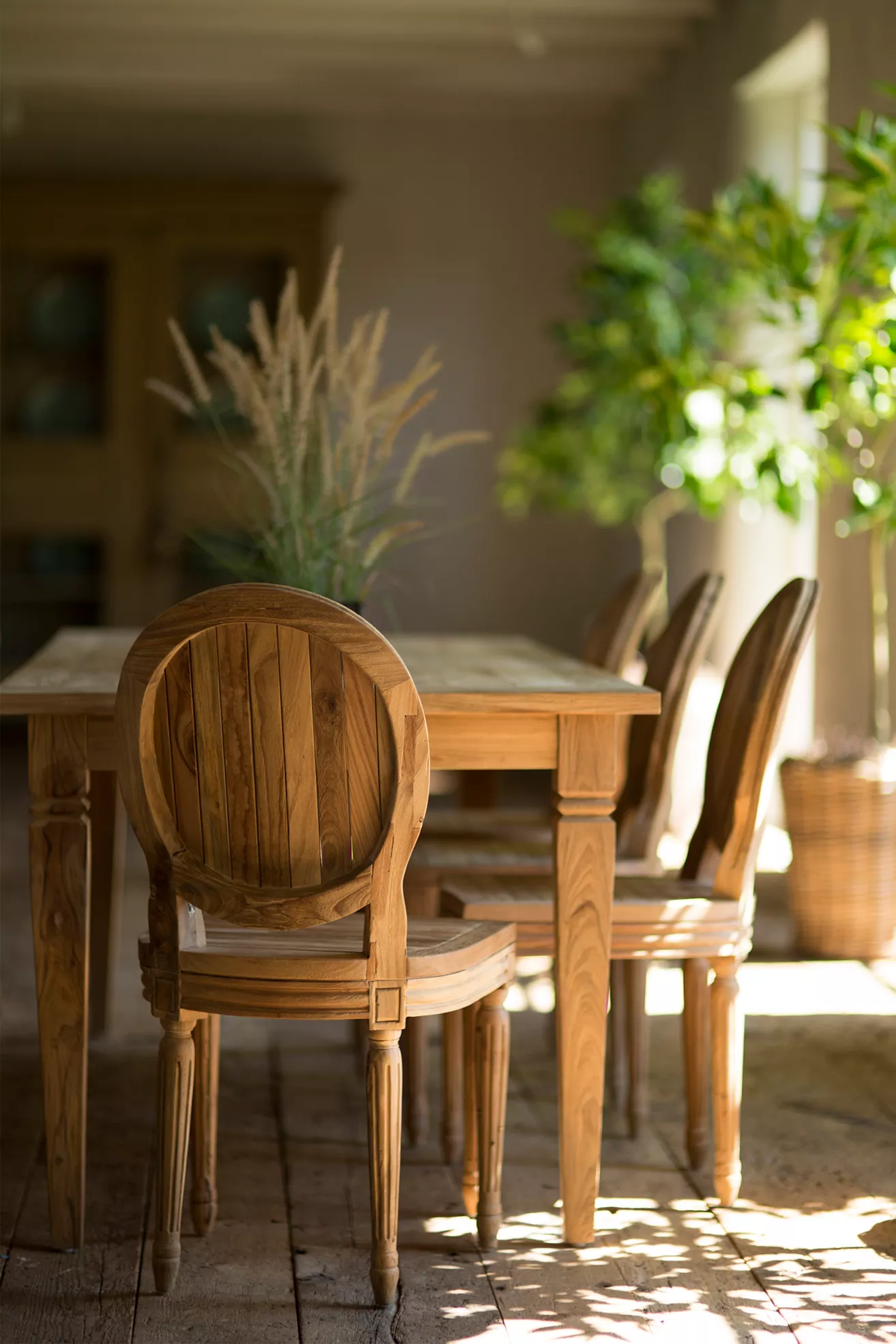Outdoor dining with multiple oval-back chairs