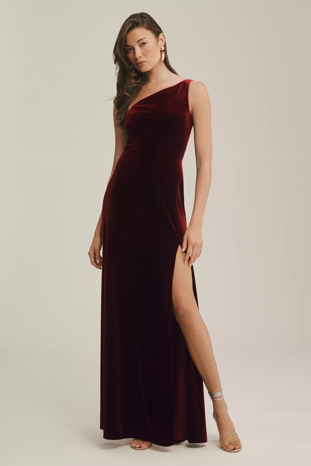 A dark-red, one-shoulder, velvet gown