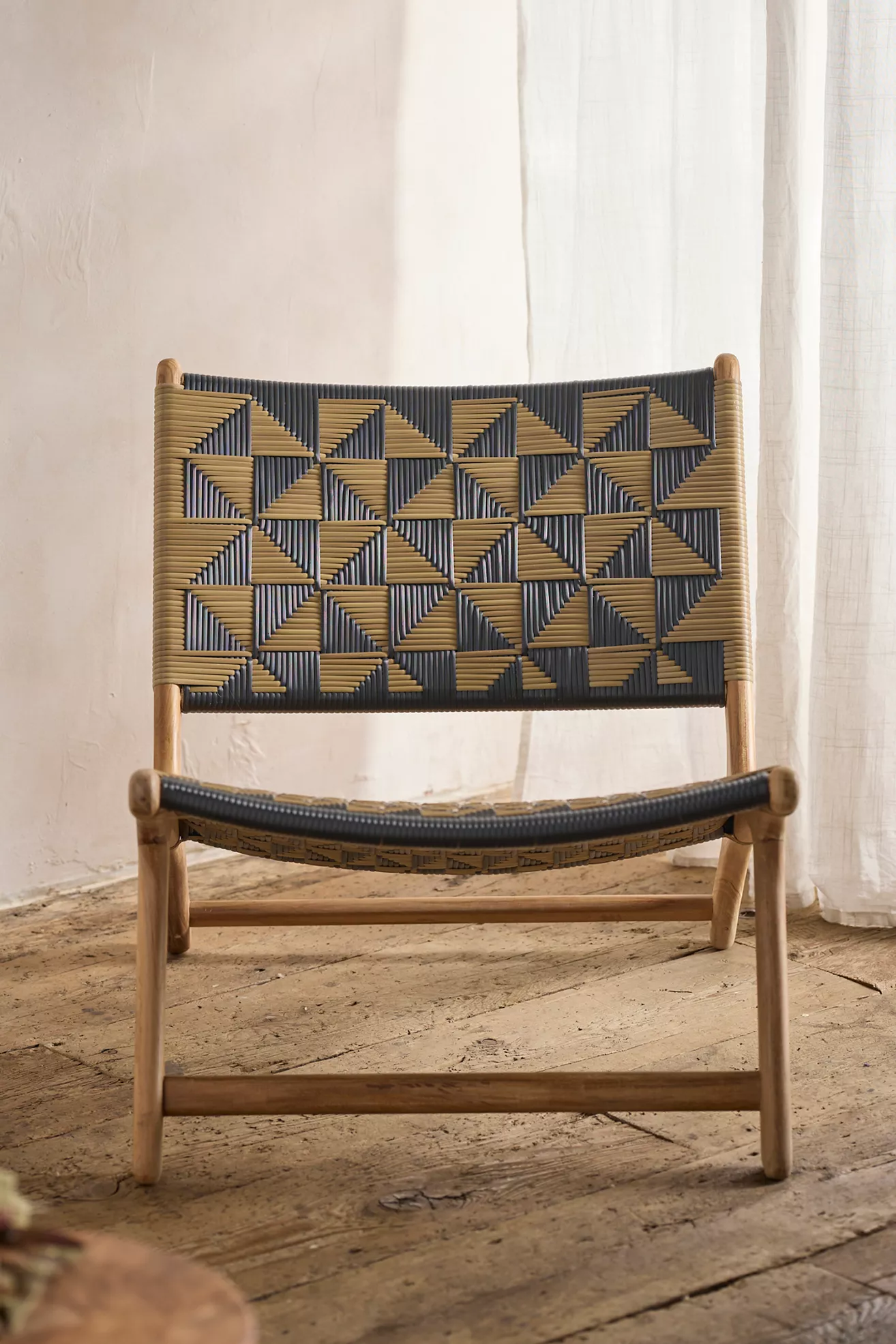 Close-up of woven pattern on chair back with black and tan strips