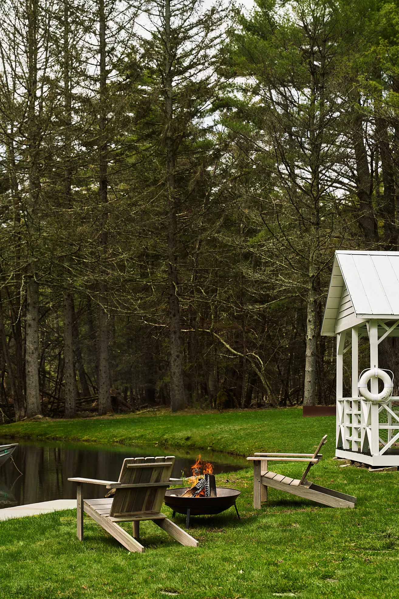 Teak Adirondack chair on lawn near gazebo