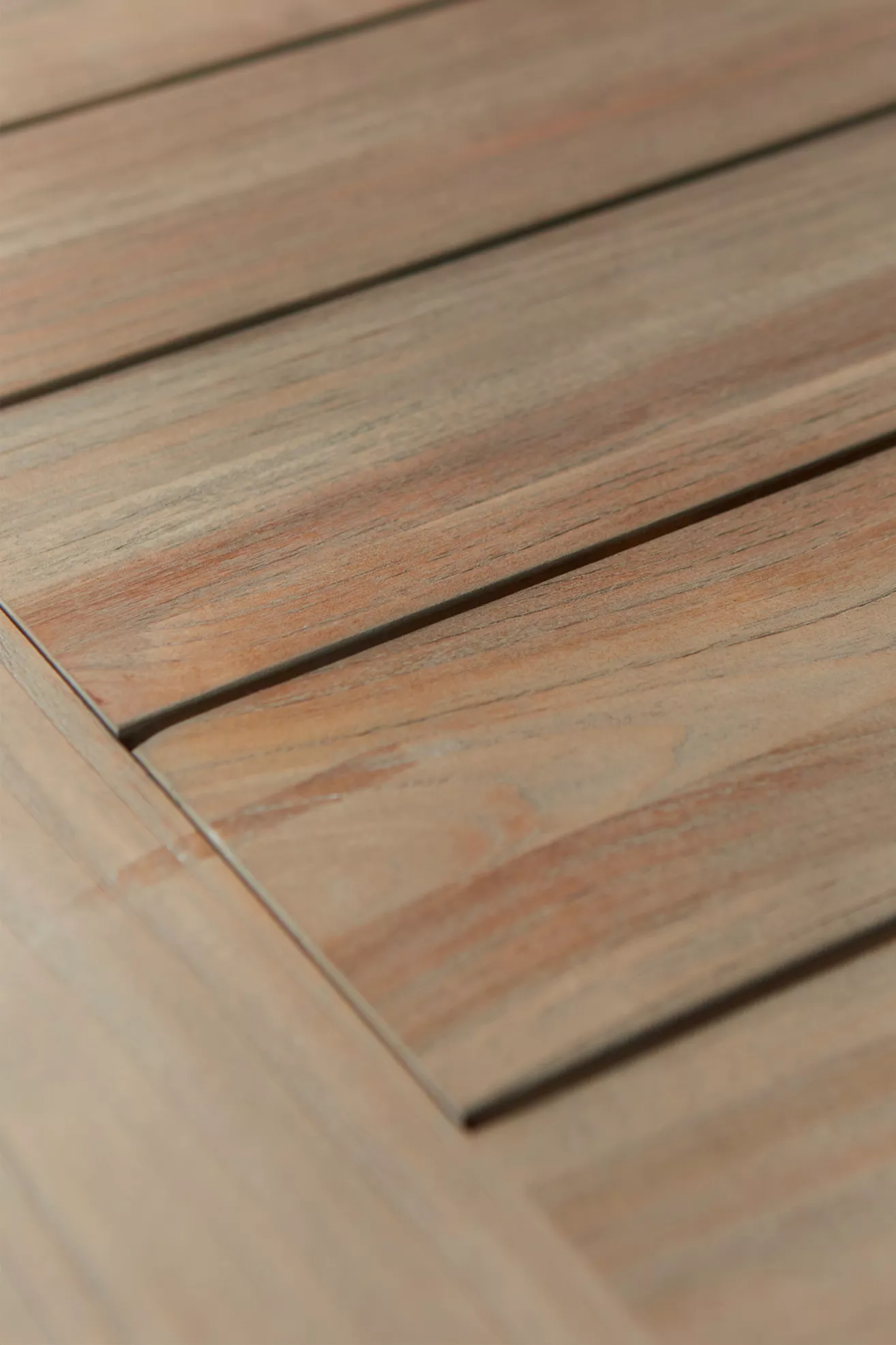 Close-up of teak wood tabletop slats showing grain