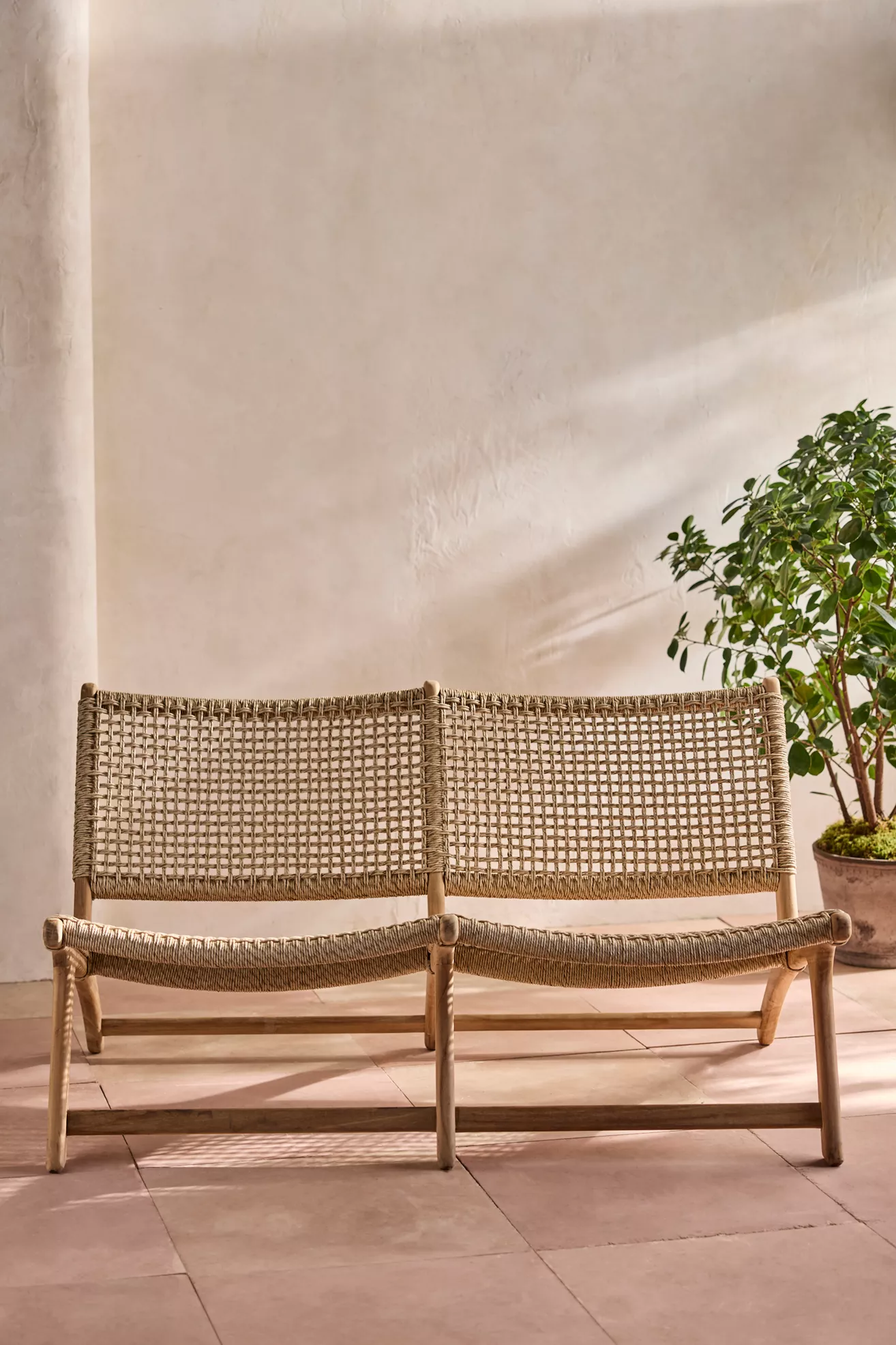 Havana open-weave two-seat armless bench showing woven back and seat grid.