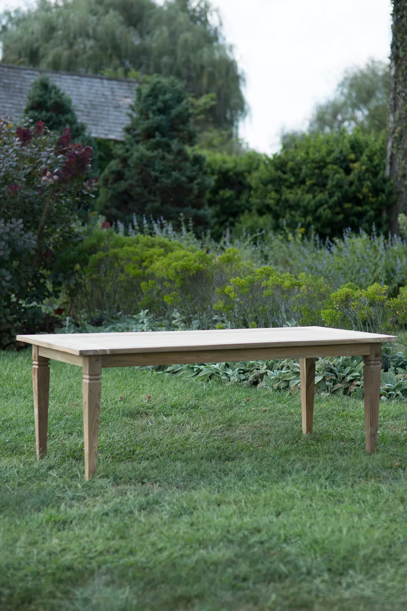 Wood dining table in a garden setting